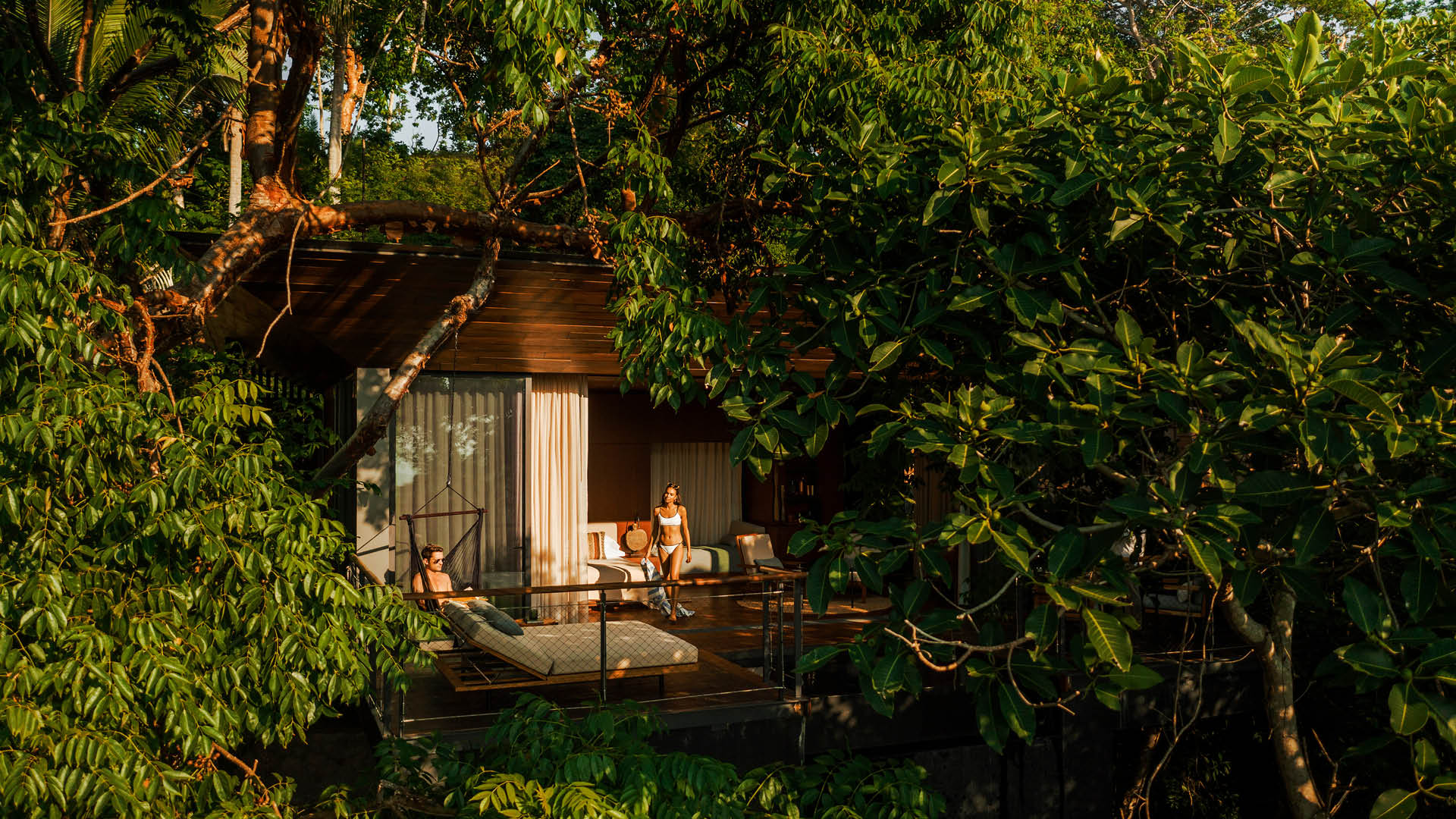 Treehouse luxury hotel with a couple sitting by the pool