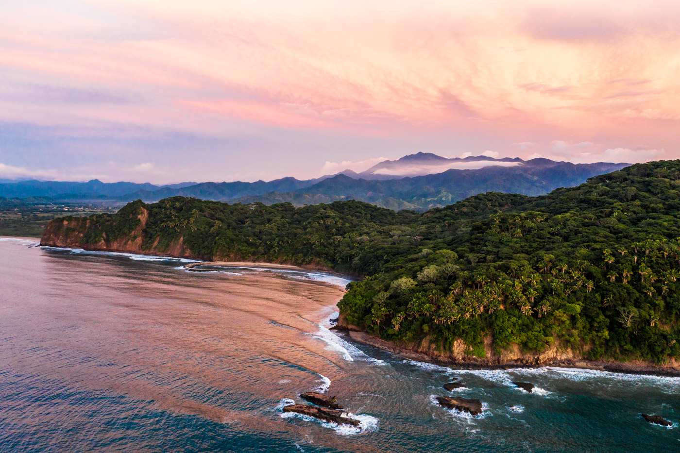 Luxury resort aerial view along the coast at sunset
